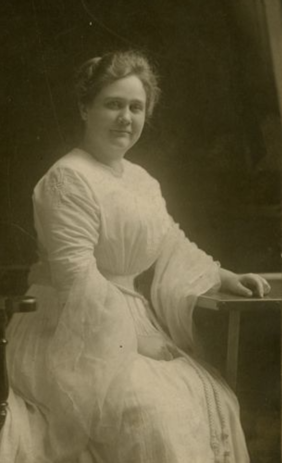 Black and white photograph of Virginia P. Moore as a young woman with a sitting post