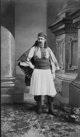 Black and white photograph of a costumed man posing 
