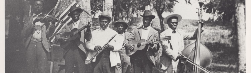 Black and white photograph of six Black musicians holding instruments