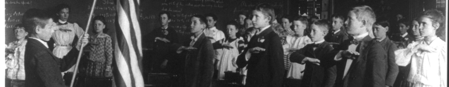 Students reciting the Pledge of Allegiance in a classroom