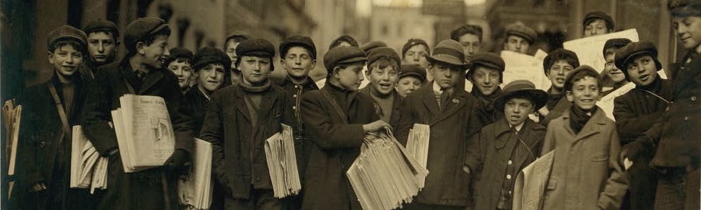 Newark newsboys lined up in the street holding newspapers