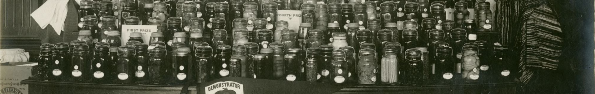 Black and white photograph of a display of canned goods