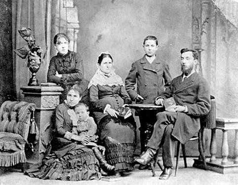 Black and white photographic portrait of a family of six